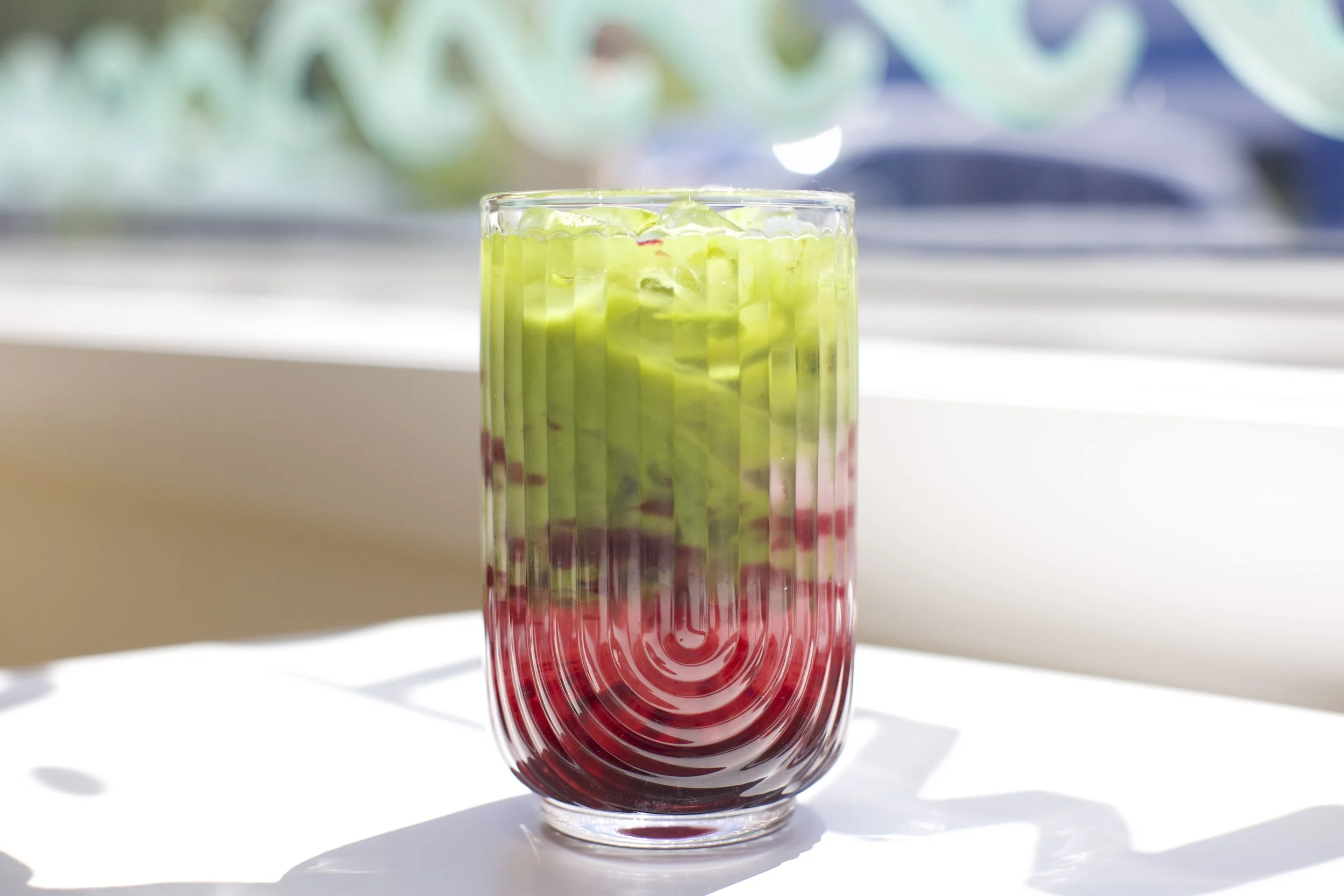 Blackberry Matcha Lemonade / Bright, refreshing lemonade layered with earthy matcha and a burst of sweet blackberry. Served iced.