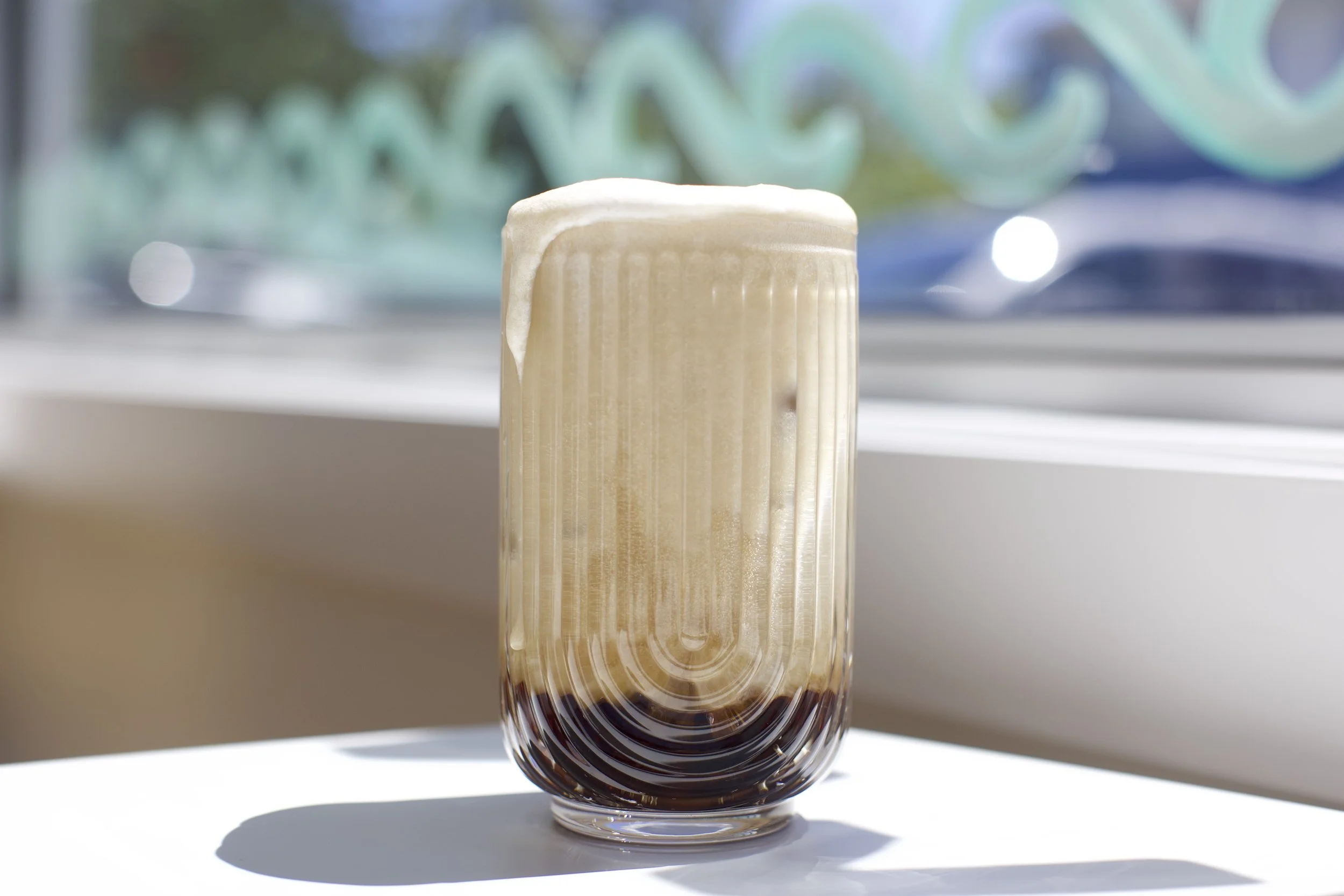 Root Beer Vanilla Bean Dirty Soda / Root beer topped with house-made vanilla sweet cream for a smooth, creamy twist on a classic favorite.