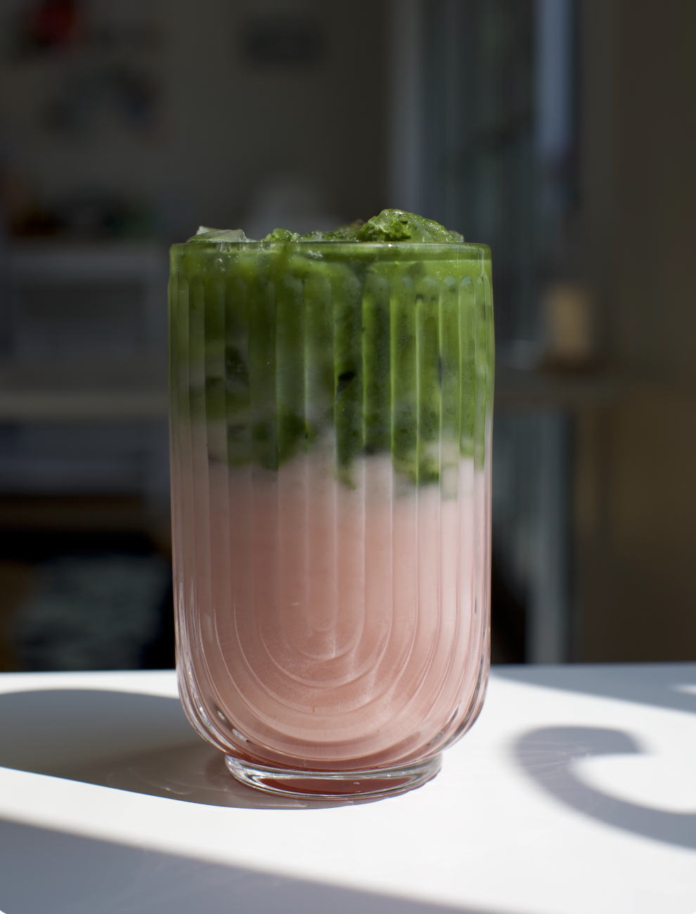 Strawberry Lover's Matcha / Creamy whole milk, layers of strawberry syrup, and real strawberry purée, finished with pure matcha over ice.