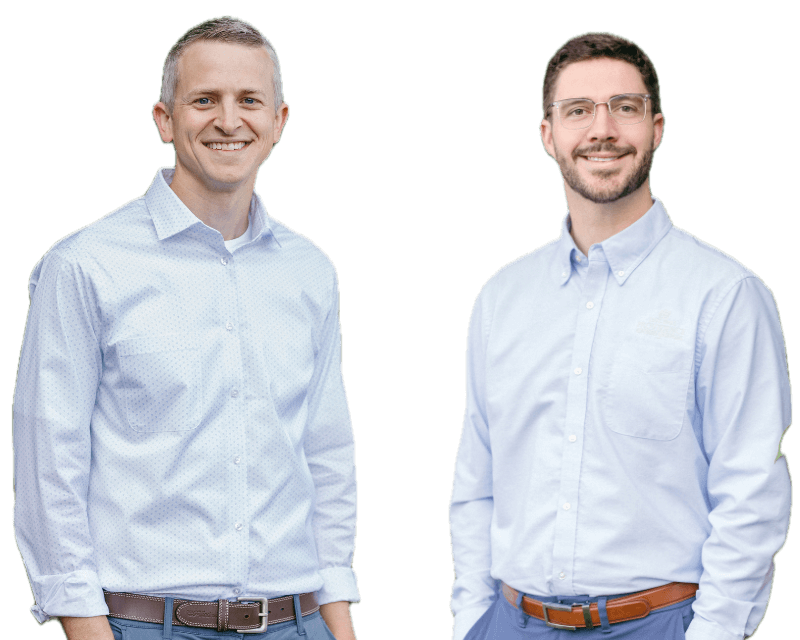 Garrett Crawford, CFP® and Adam Reed co-hosts of The Retirement Tax Matters podcast smiling men wearing light blue button-up shirts standing against a black background.