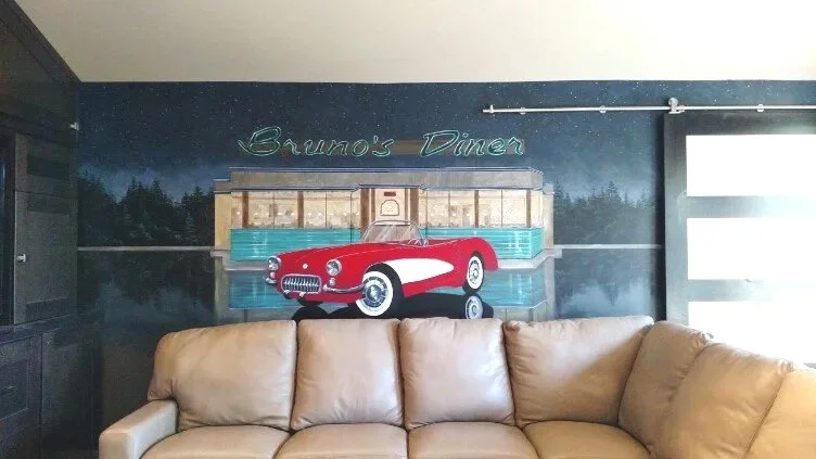 Mural in front of a sliding barn door.