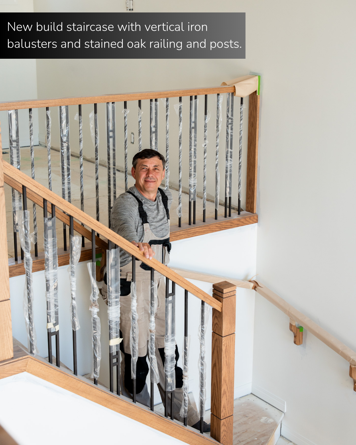 new build staircase with vertical iron balusters and stained oak railing and posts. 