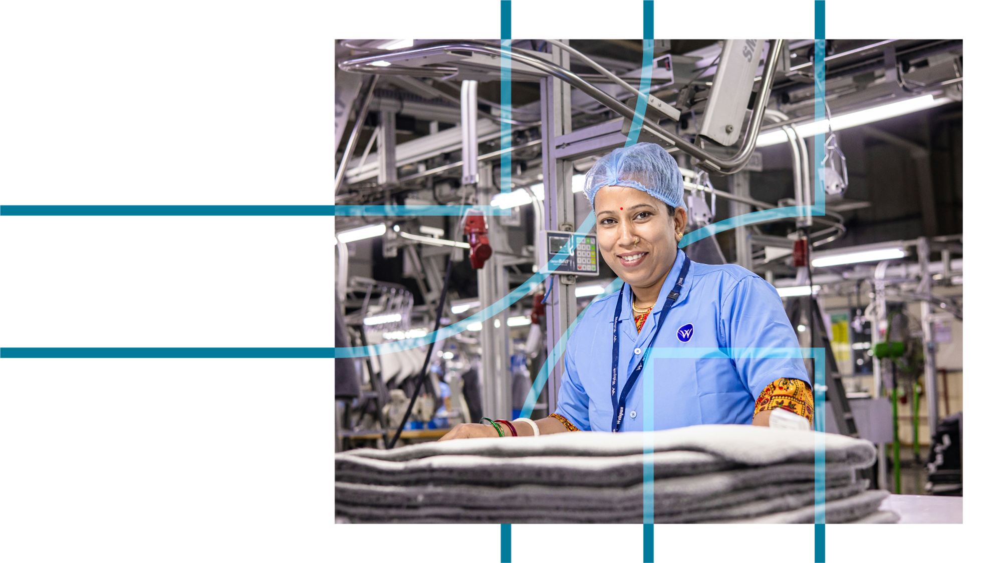 A woman in a light blue uniform and hairnet working in a textile or garment factory surrounded by industrial equipment and fabrics.