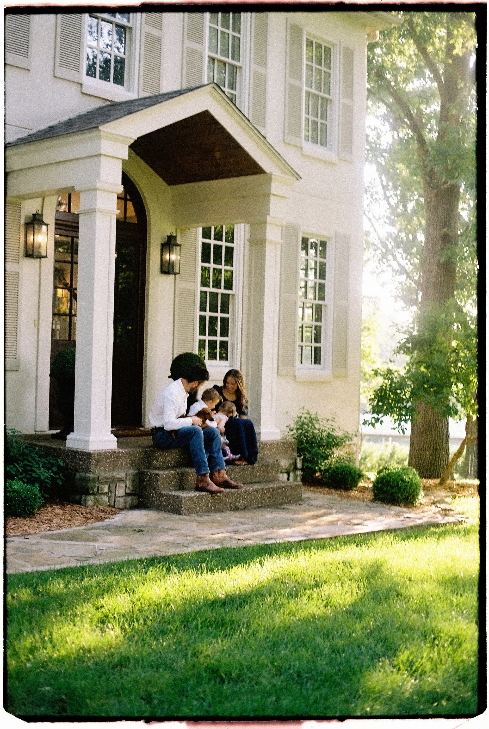 Family photographed at home during a candid 35mm film session near Springfield, Missouri.