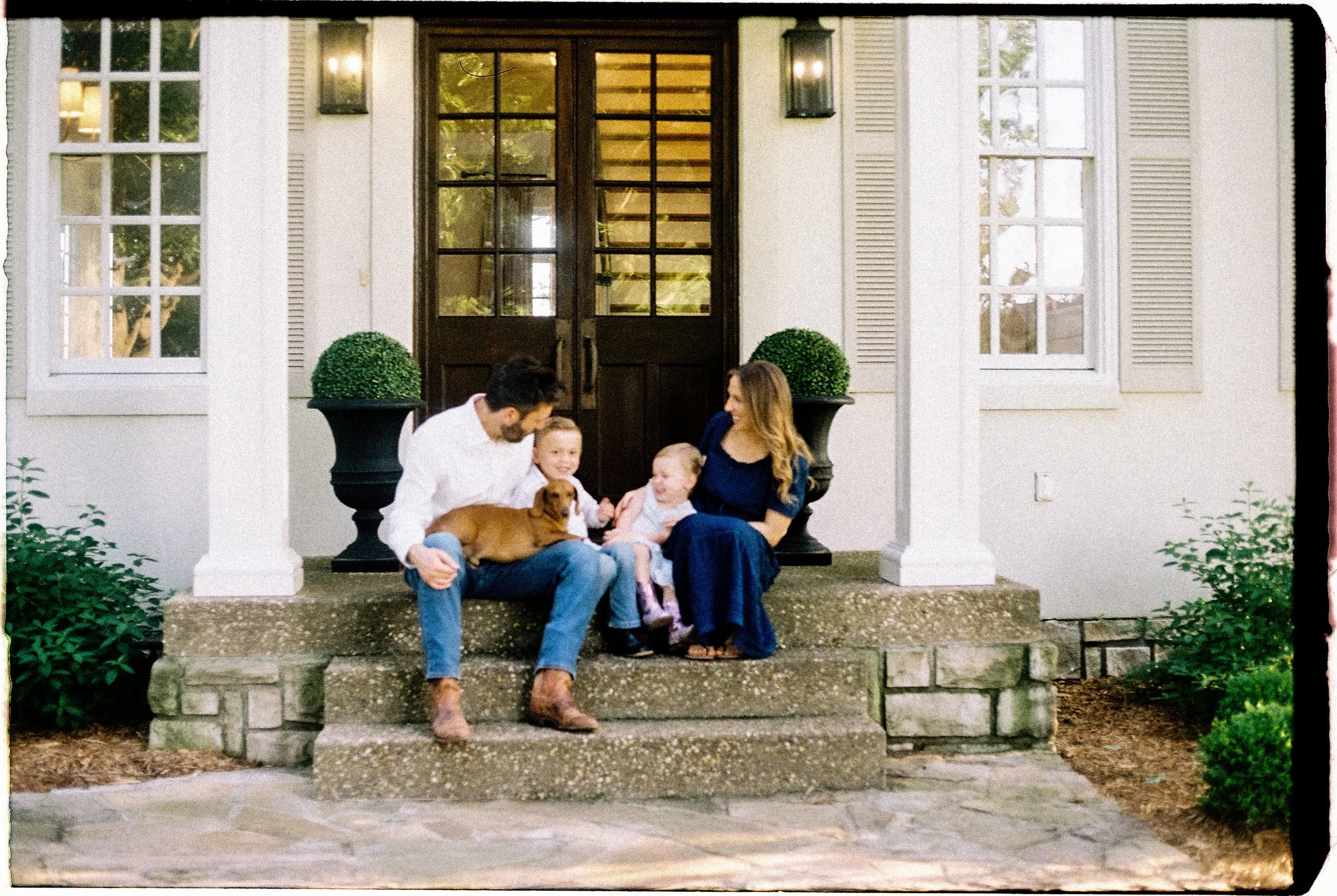 Family photographed at home during a candid 35mm film session near Springfield, Missouri.