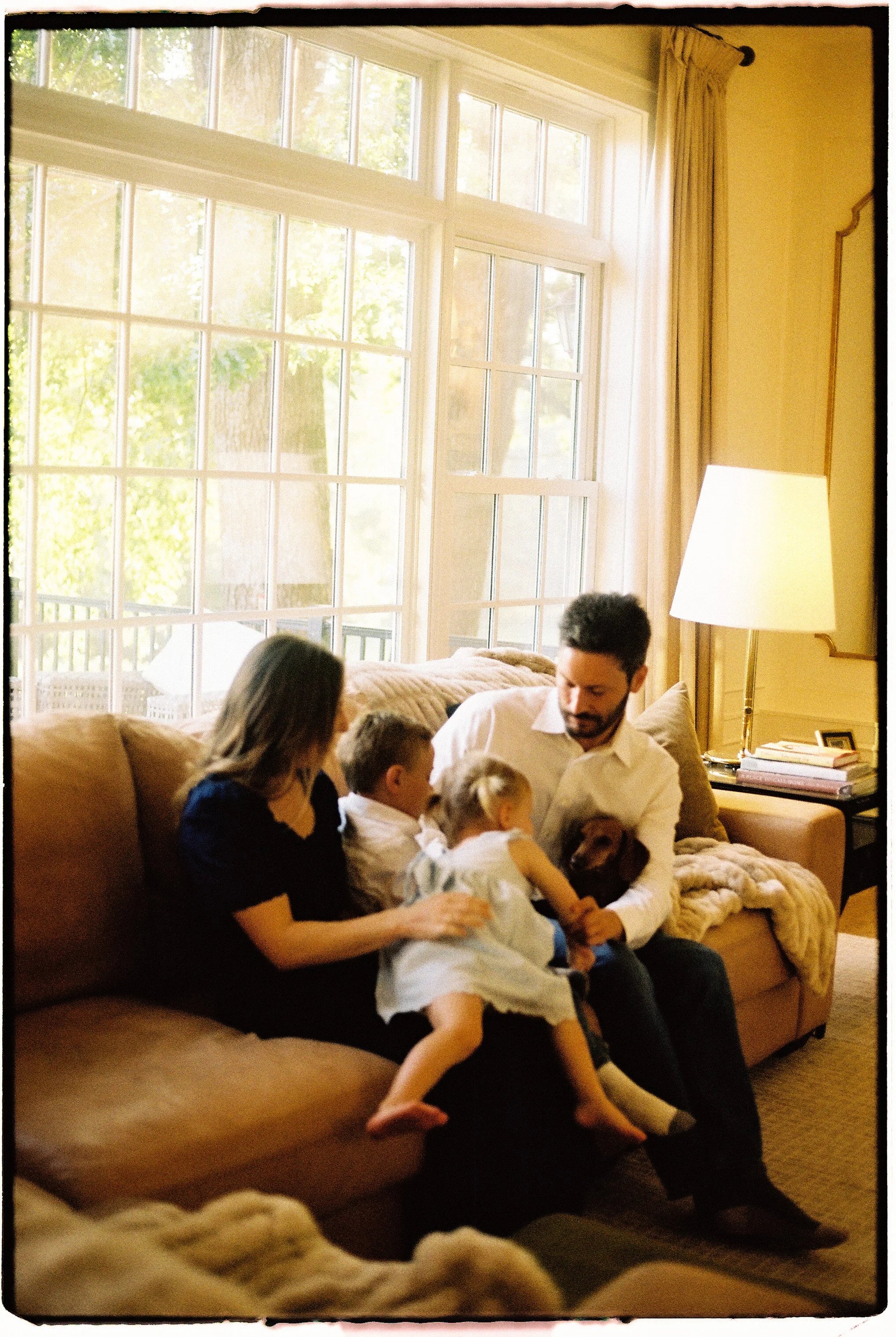 Family photographed at home during a candid 35mm film session near Springfield, Missouri.