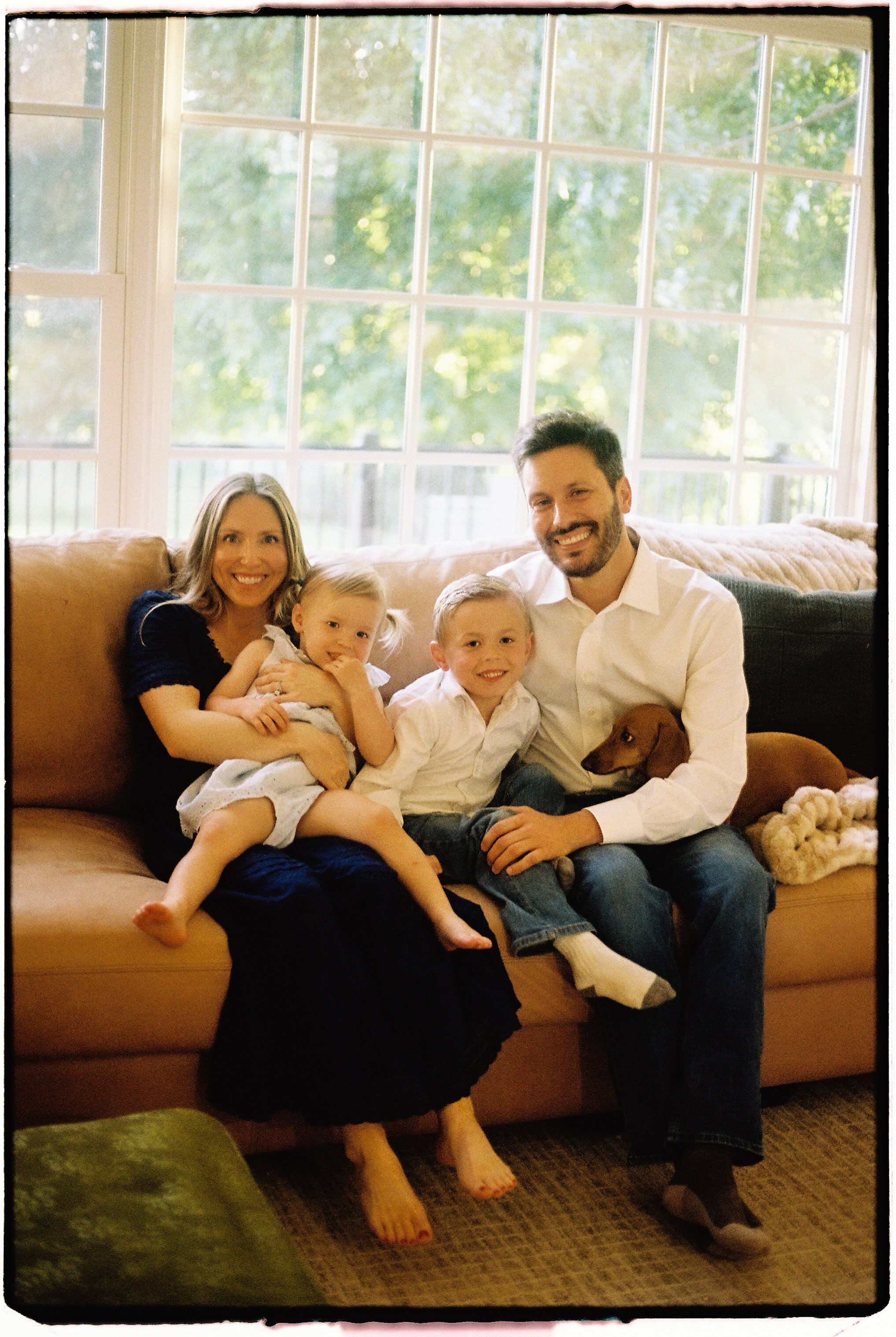 Family photographed at home during a candid 35mm film session near Springfield, Missouri.