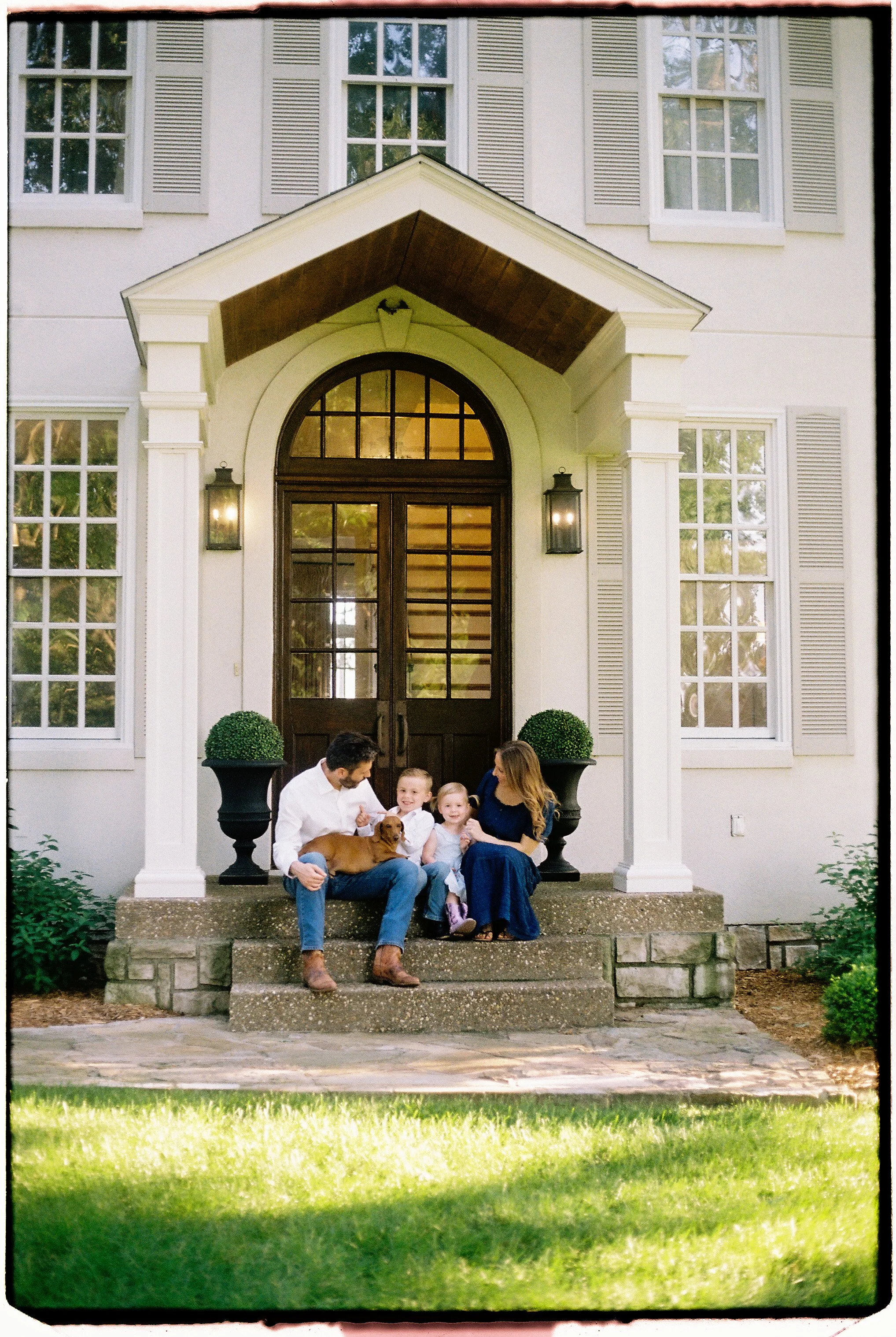Family photographed at home during a candid 35mm film session near Springfield, Missouri.