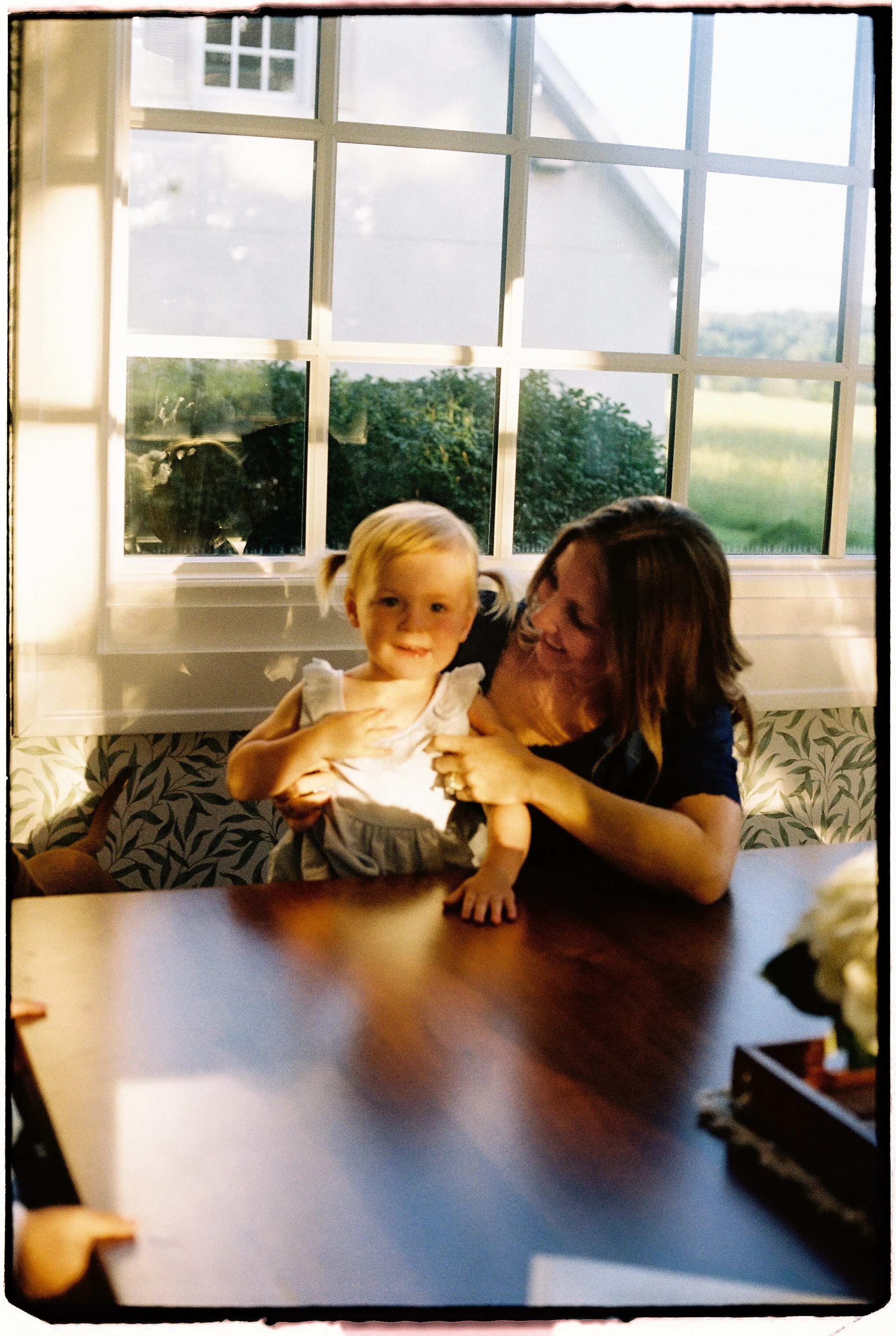 motherhood photographed at home during a candid 35mm film session near Springfield, Missouri.