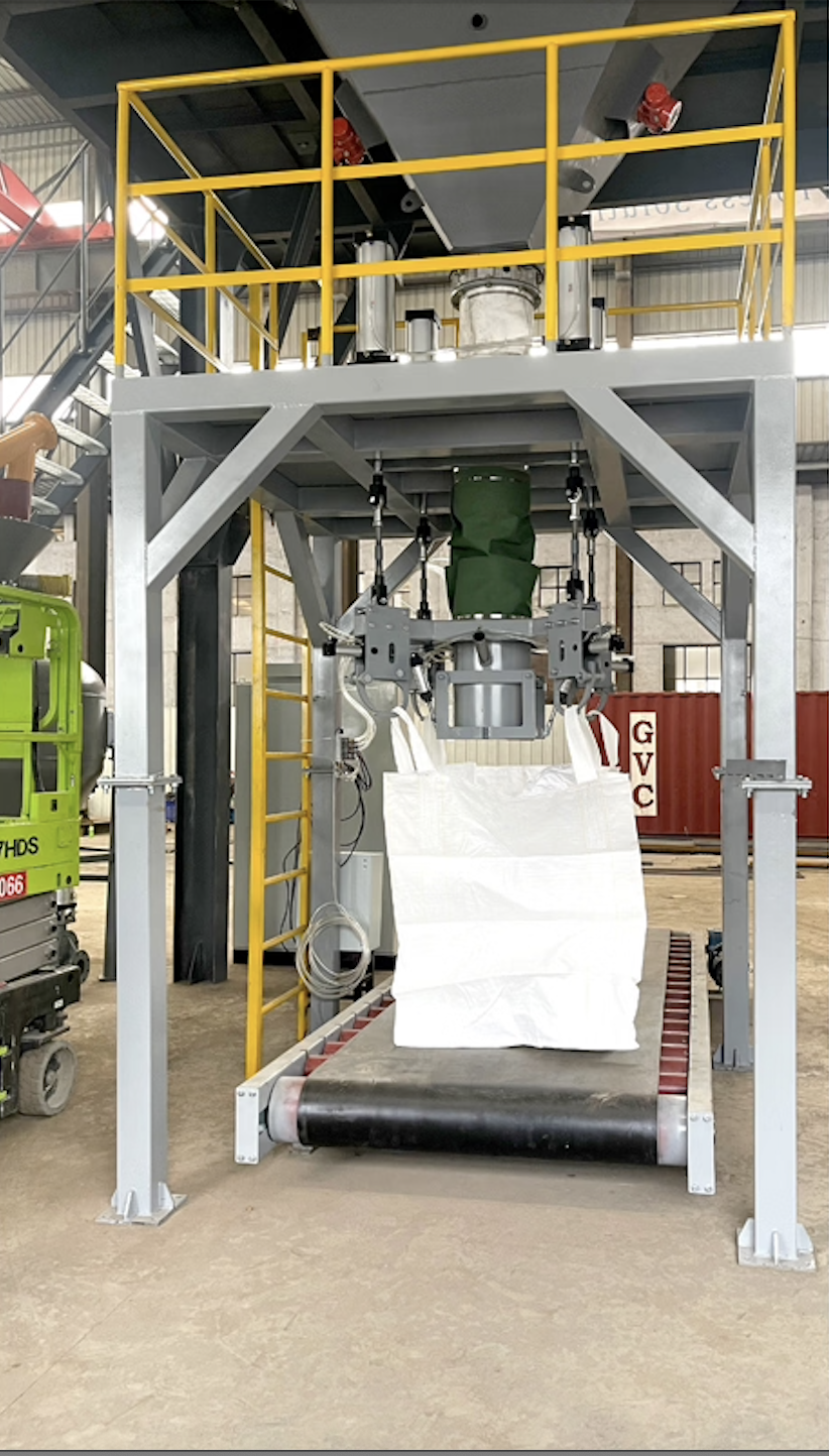 Industrial machine with a yellow safety railing, conveyor belt, and a robotic arm holding a white bag in a warehouse.