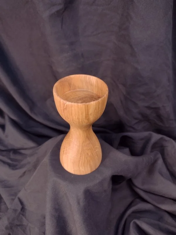 Turned wood with unique shape and central bowl.