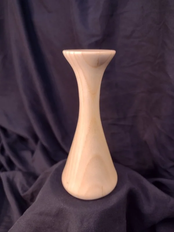 Turned wood with unique shape and central hole.