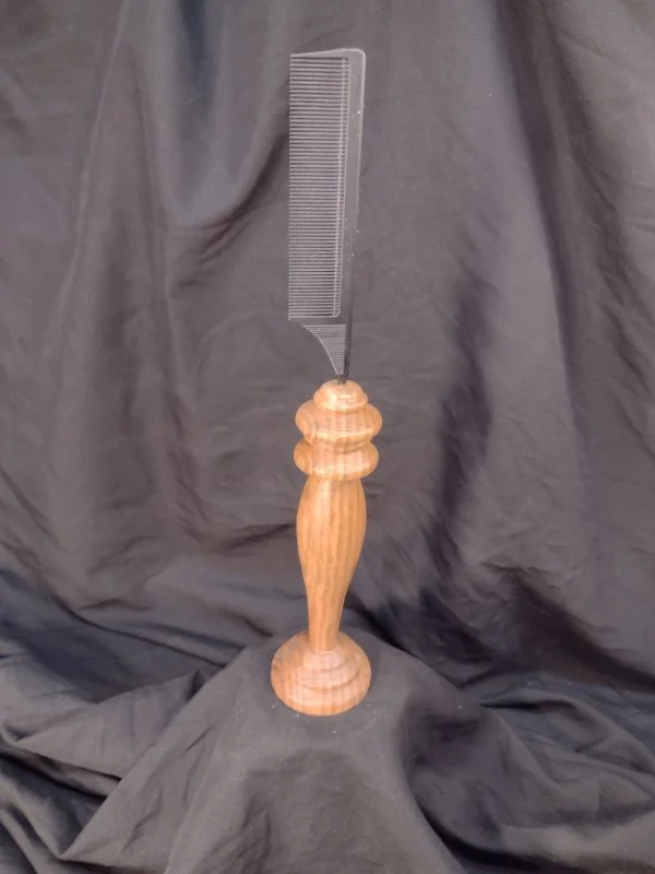 A wood handled comb that sits upright.