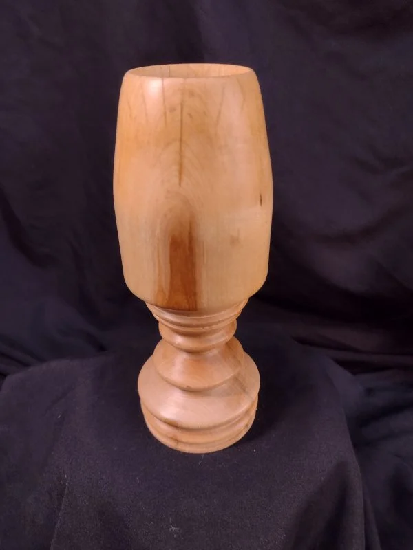 Turned wood with a central hole.