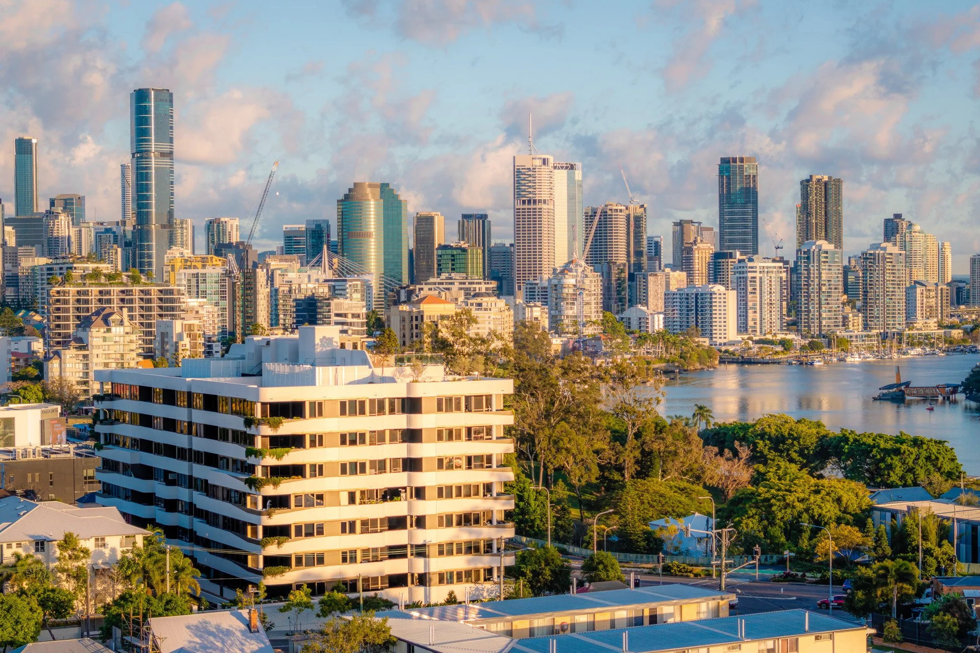 Brisbane city skyline with tall buildings and skyscrapers and Mowbray Apartment building in the foreground