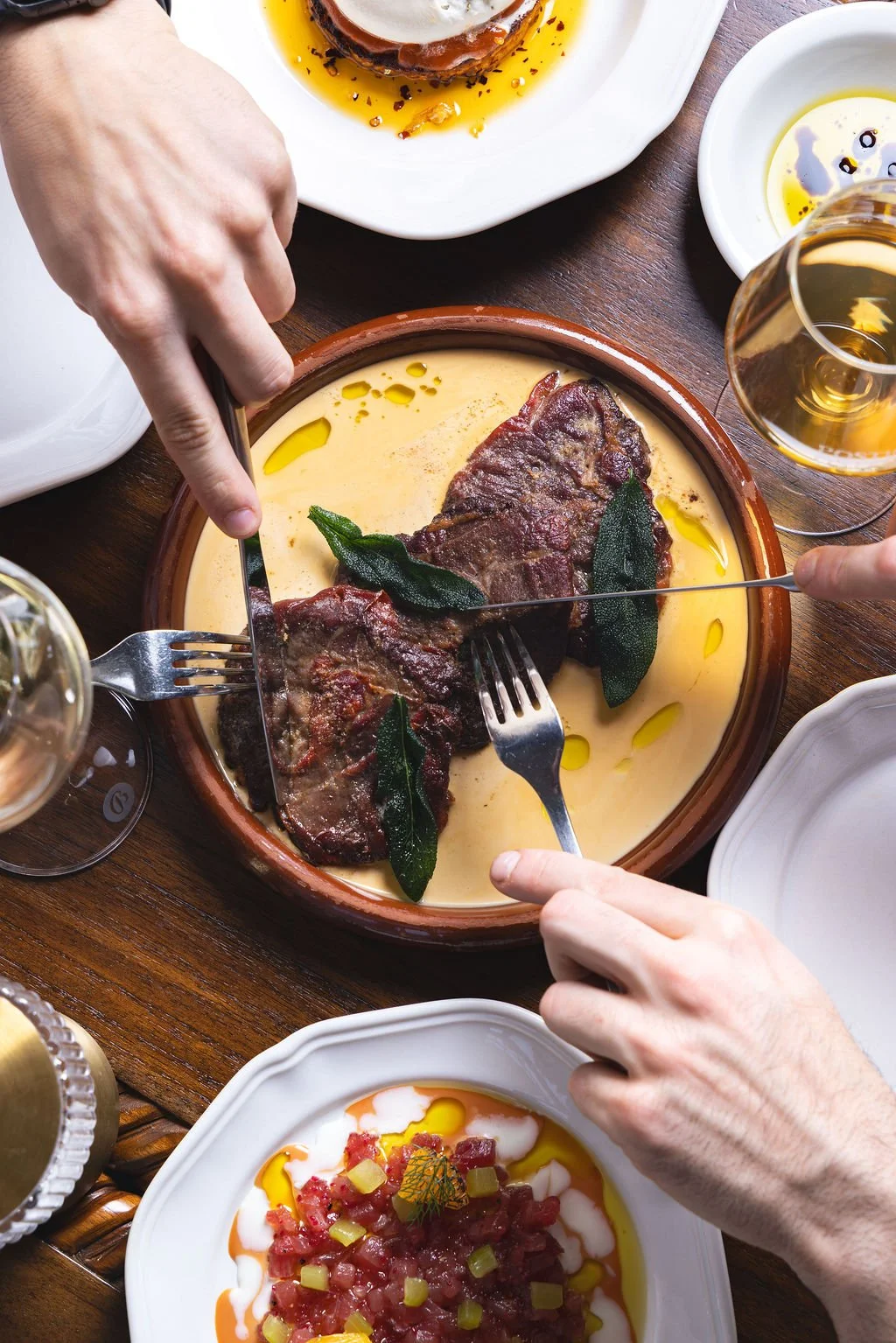 People sharing a plate of the classic Italian dish Saltimbocca