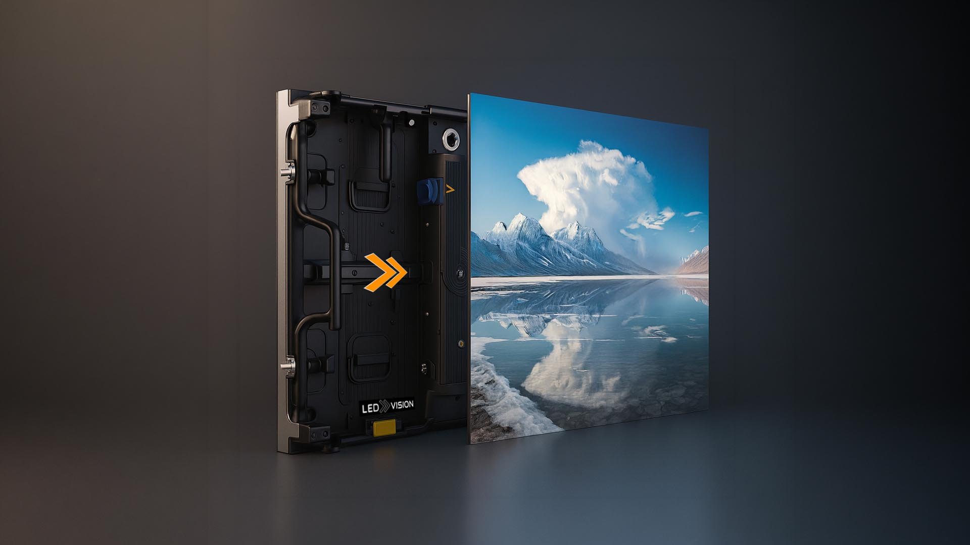 A close-up of a partially disassembled large flat-screen LED television displaying an image of a serene mountain lake scene with snow-capped mountains, blue sky, and white clouds. The back panel and internal components of the TV are visible.