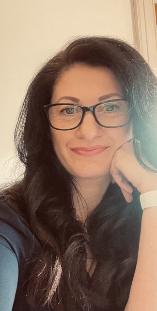 Sami leaning on hand casually smiling