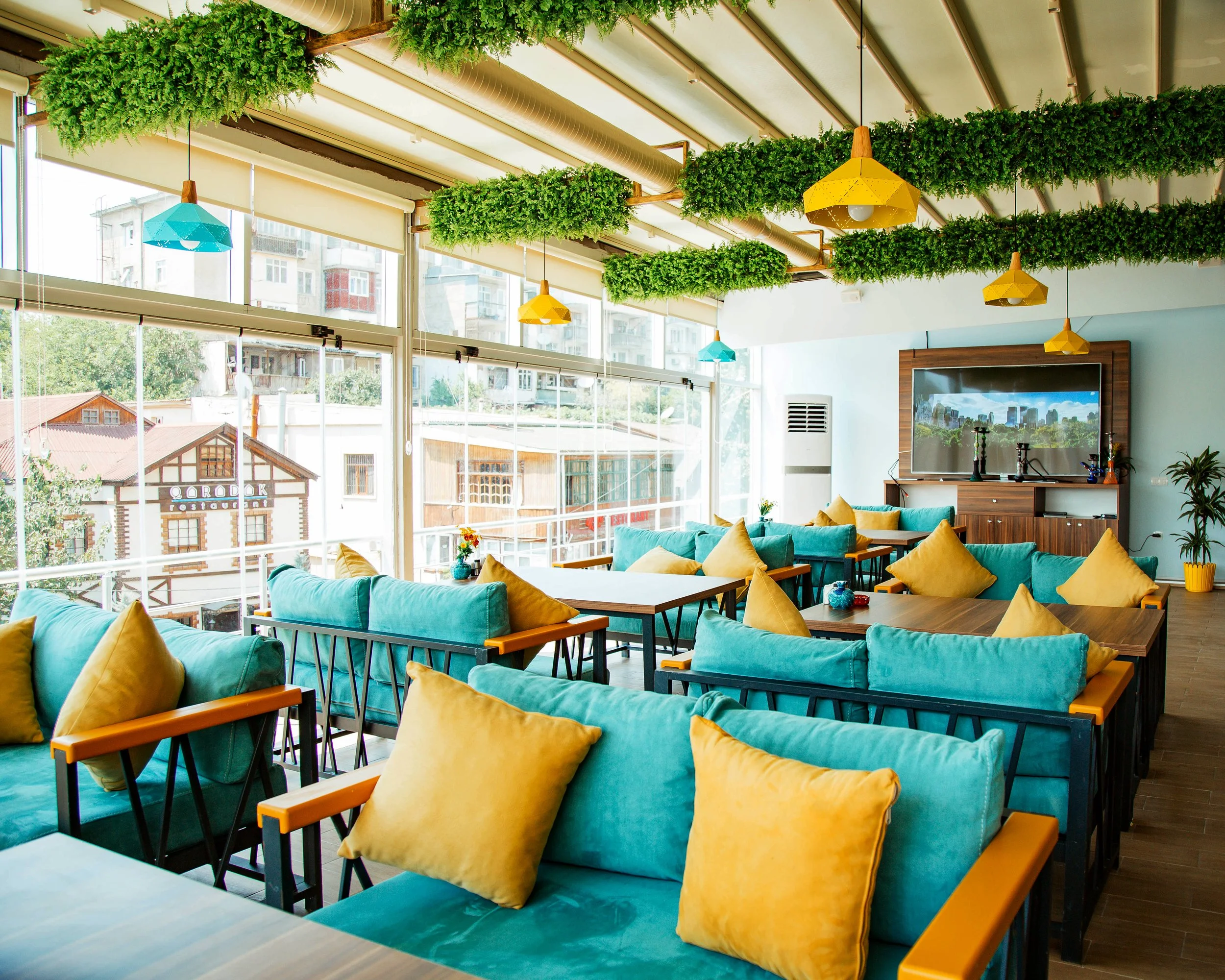 cafe-terrace-with-turquoise-sofas-yellow-pillows.jpg