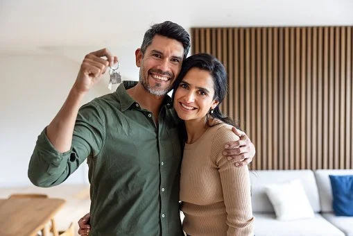 A happy couple receiving their new home keys