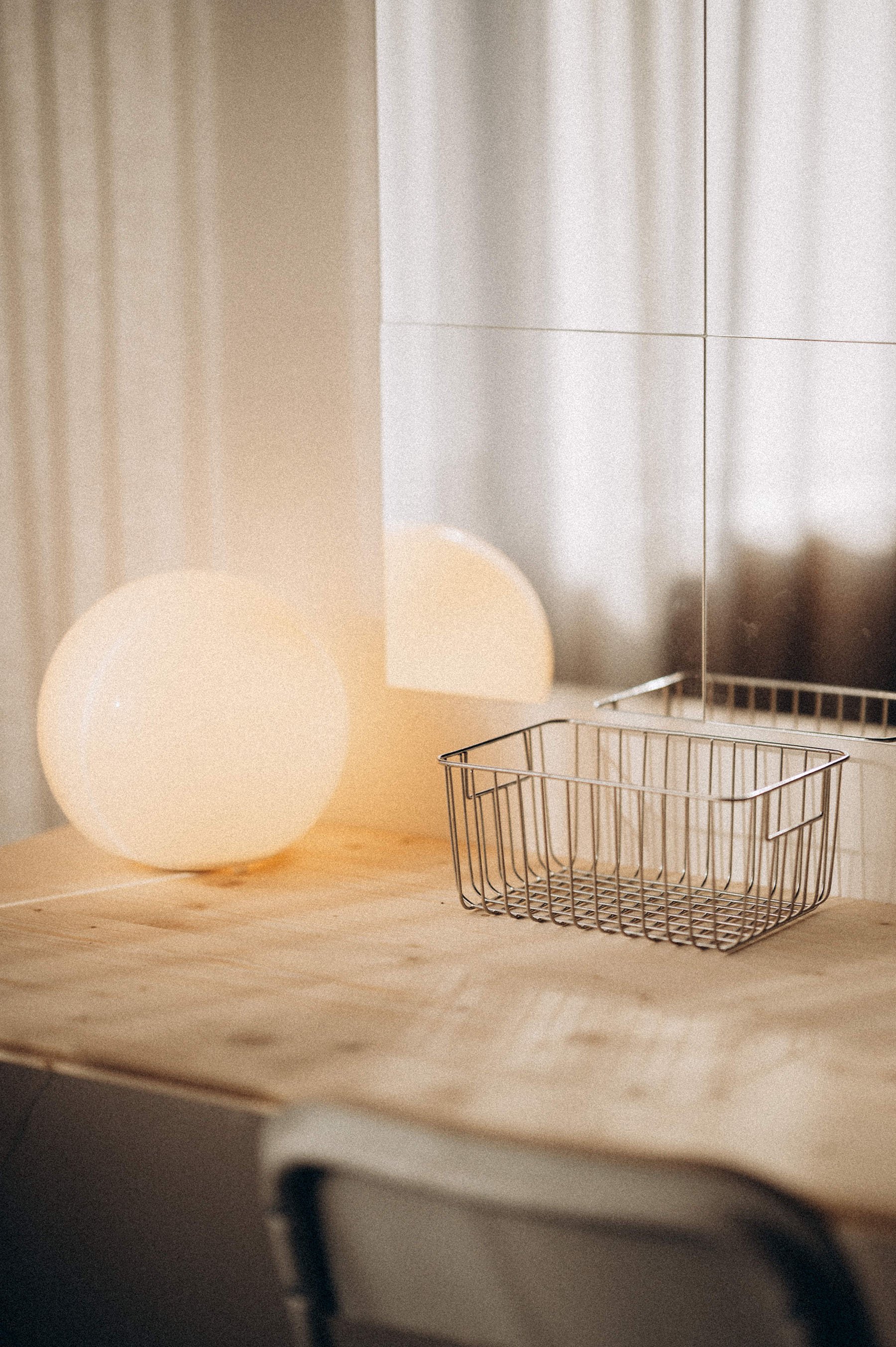 white ball lamp on a table with a mirror