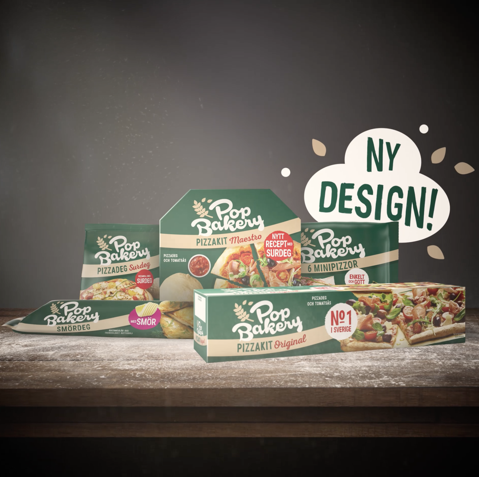 Various boxed frozen pizza products from Pop Bakery arranged on a wooden table with a gray background. A speech bubble indicates 'NY DESIGN!'