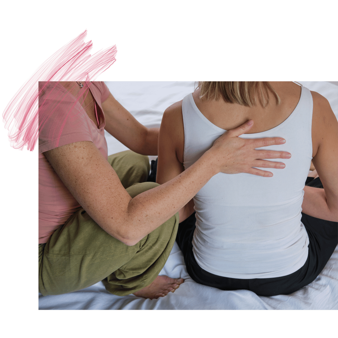 Therapist places hand on client's upper back for bodywork