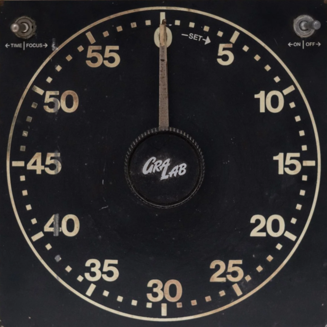 A vintage black stopwatch with cream-colored numbers from 0 to 60, showing 0 seconds, with the brand name 'Gray Lab' in the center.