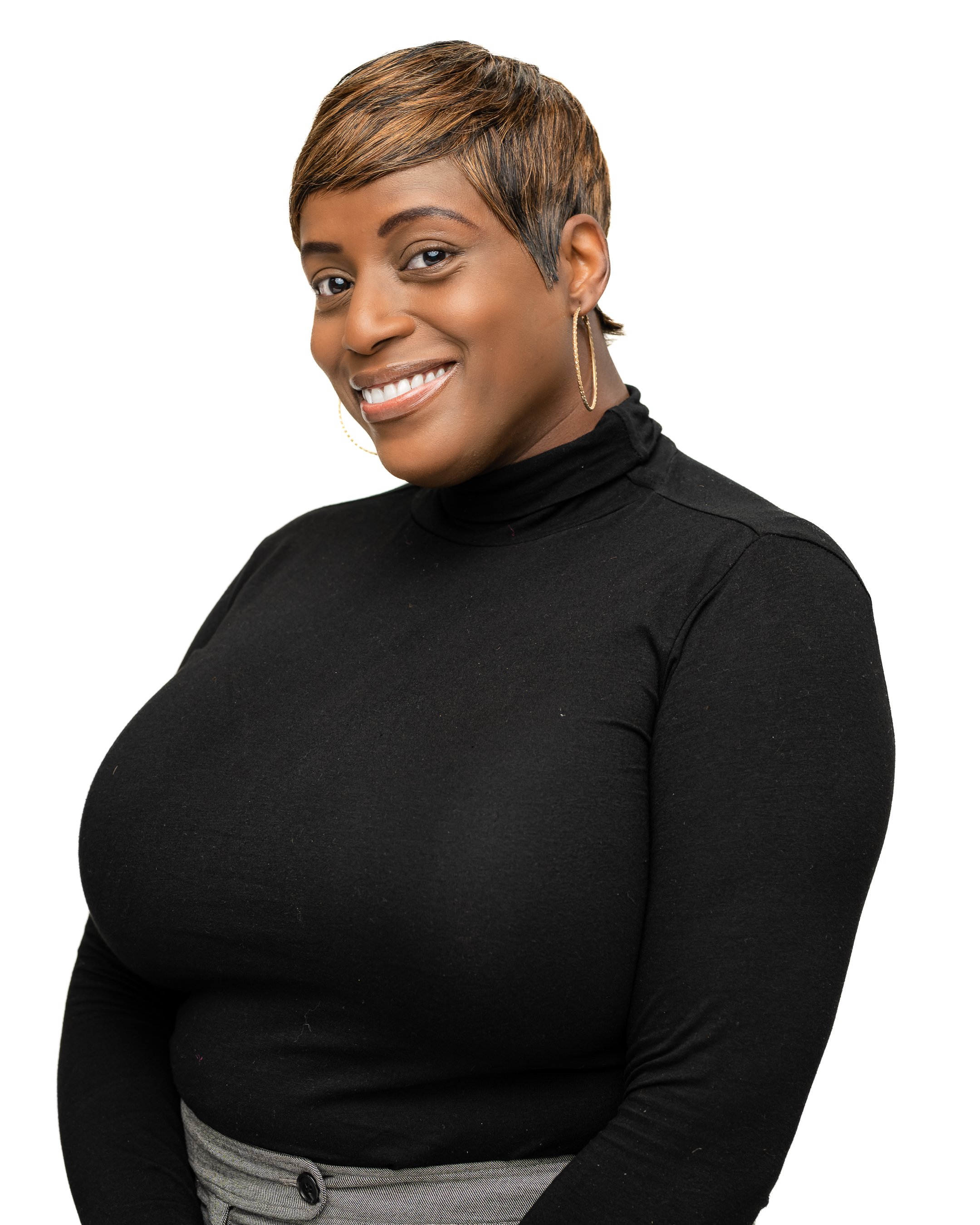 A smiling woman with short hair wearing a black turtleneck and hoop earrings against a white background.