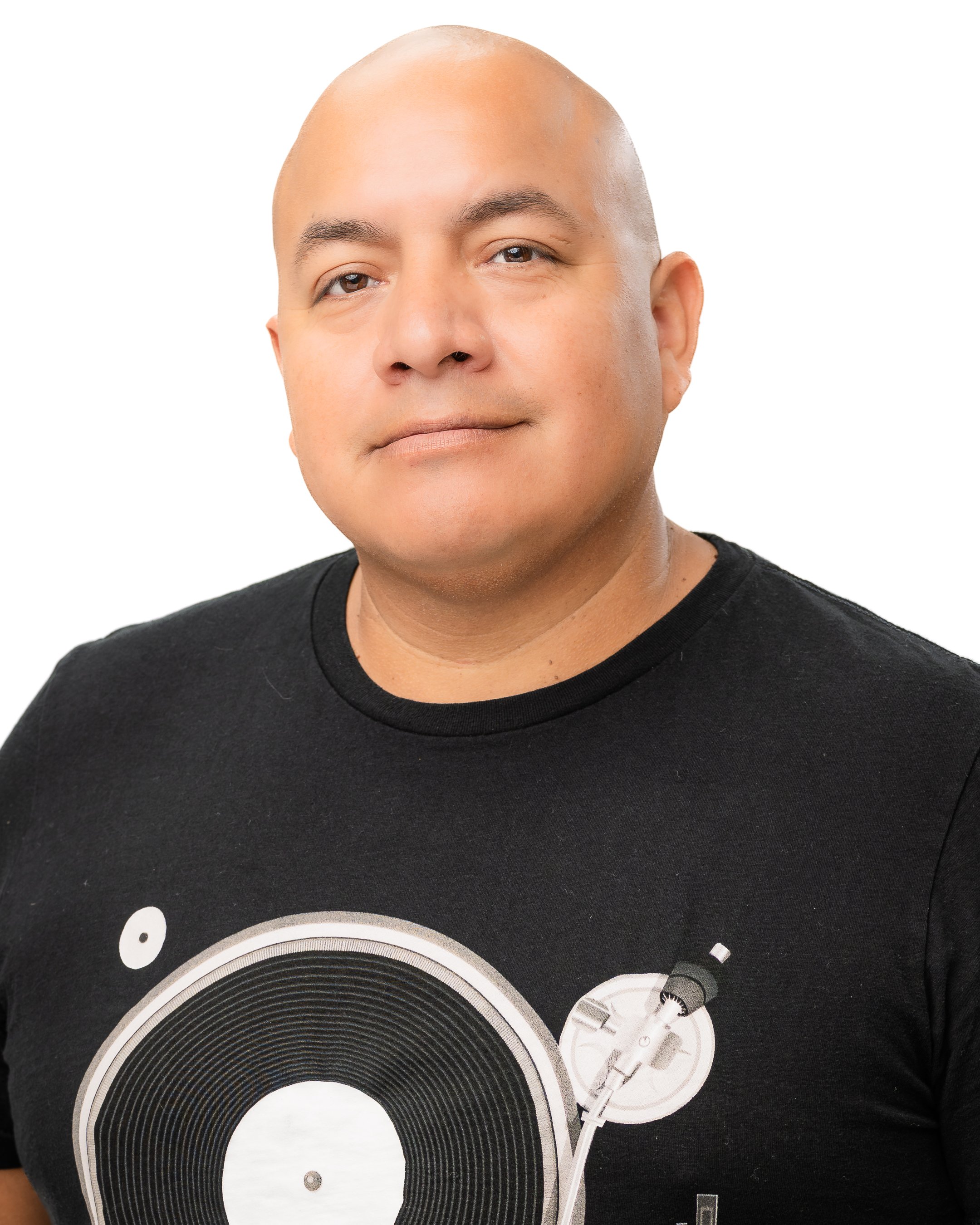 A man with a shaved head wearing a black T-shirt with a vinyl record and turntable design.