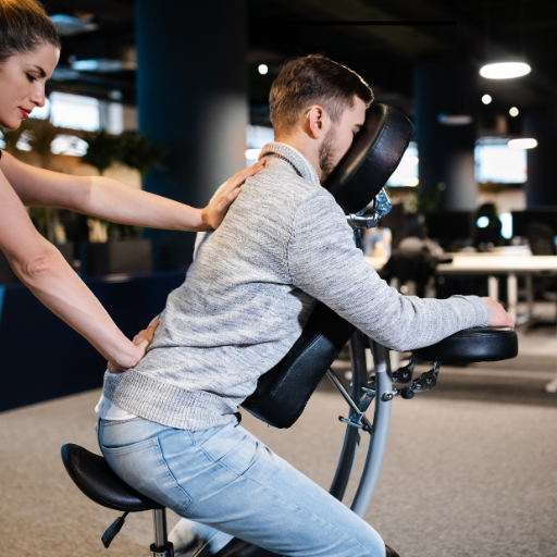 A woman helping a man with a massage at a fitness or therapy center.