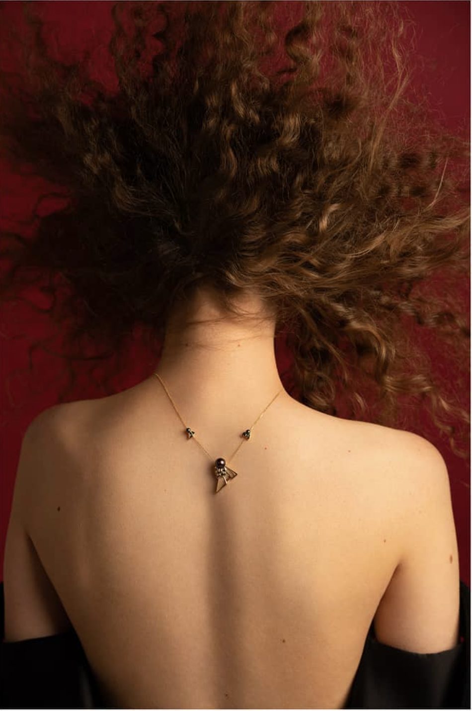 Fine necklace worn down the back, jewellery photography by To The Peak, DubaiBlue chronograph watch, product photography by To The Peak, Dubai