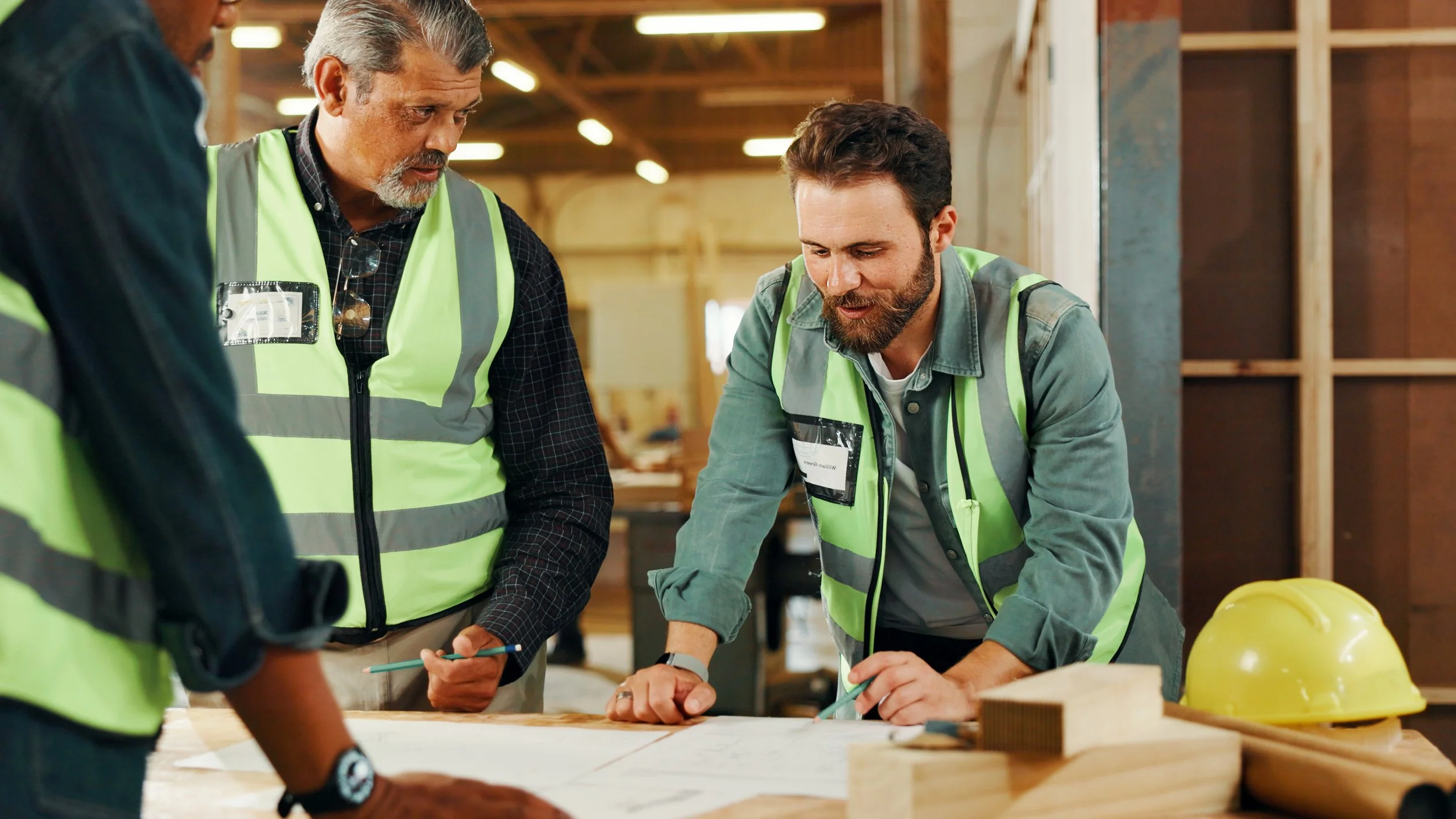 Restoration specialists reviewing blueprints on-site during a residential reconstruction project in the Greater Toronto Area.