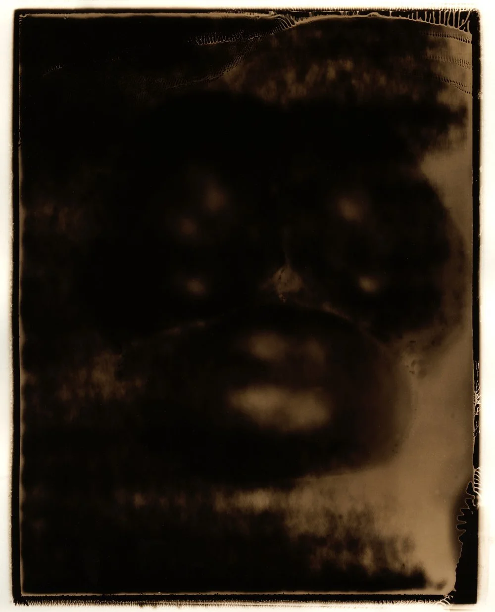 A dark, monochromatic portrait of the bottom of a bell pepper, creating a dramatic and abstract effect. Created by Sam Devine Tischler © all rights reserved