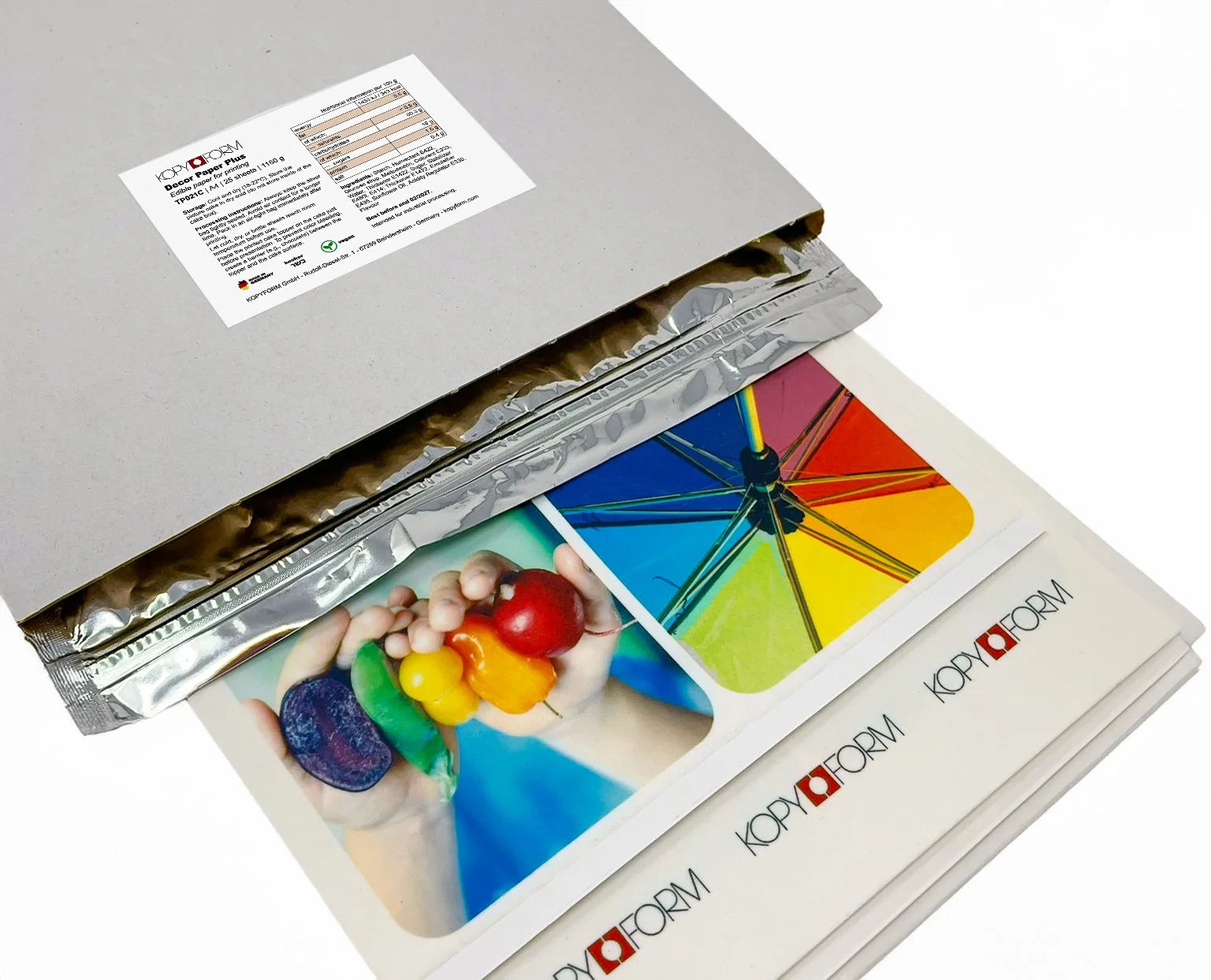 A stack of print paper with colorful images of a rainbow umbrella, a child's hand holding toys, and a rainbow-colored object inside a box.