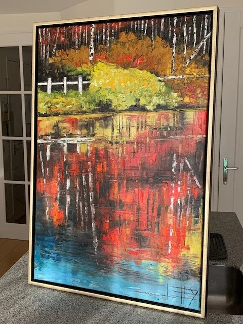 An abstract landscape painting depicting trees with fall foliage, a white fence, and a body of water reflecting the vibrant colors.