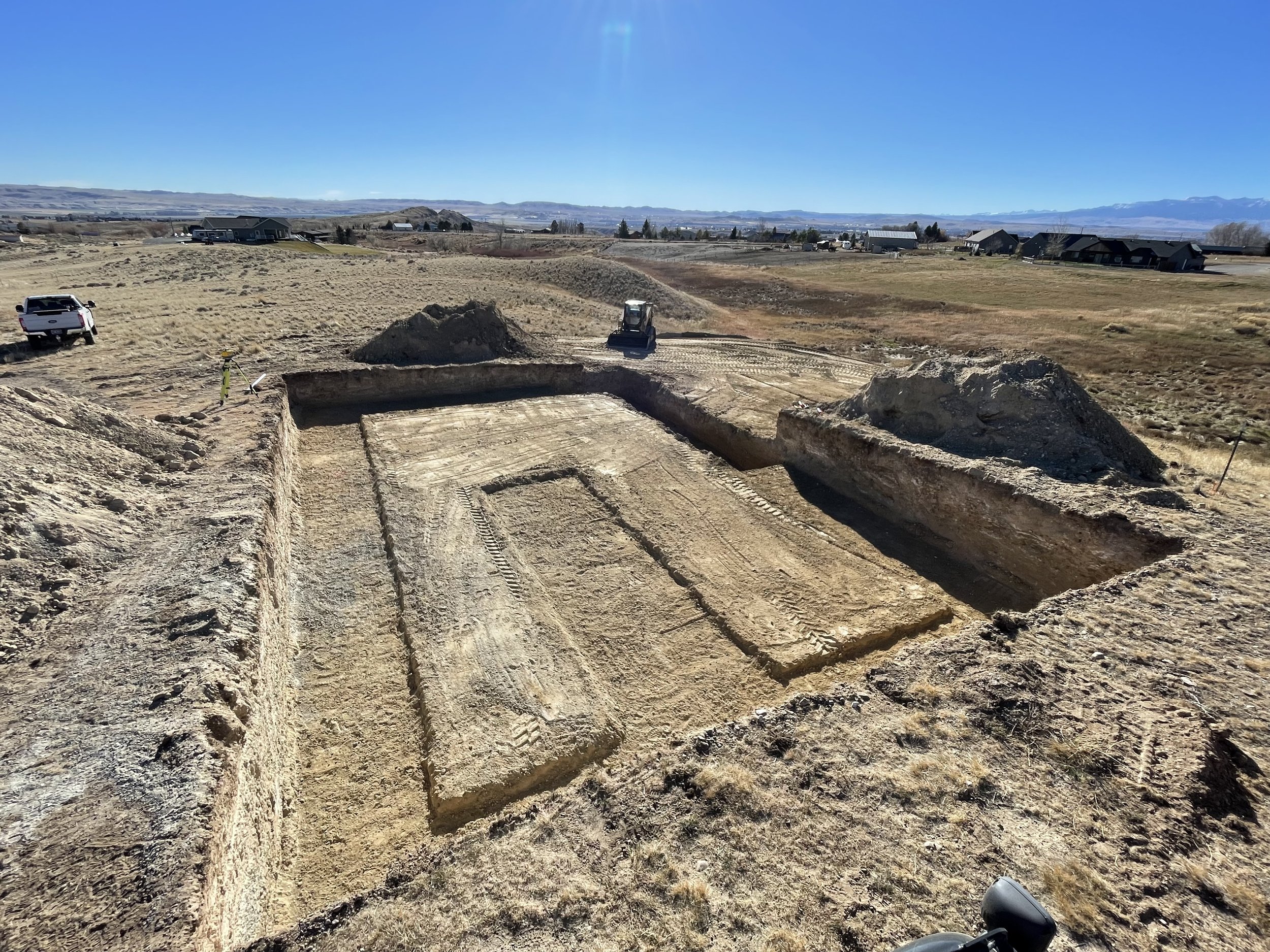 Park County excavation dirt work Cody Wyoming Powell basement walk out sewer line septic tank footings foundation excavator