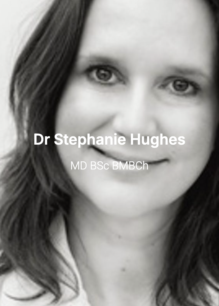 Black and white portrait of Dr. Stephanie Hughes with long dark hair and light eyes, smiling slightly.