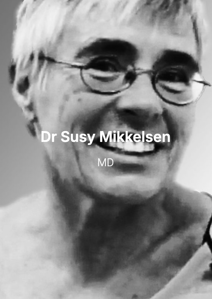 Black and white photo of a smiling woman with short hair and glasses. Text overlay reads: "Dr Susy Mikkelsen, MD".