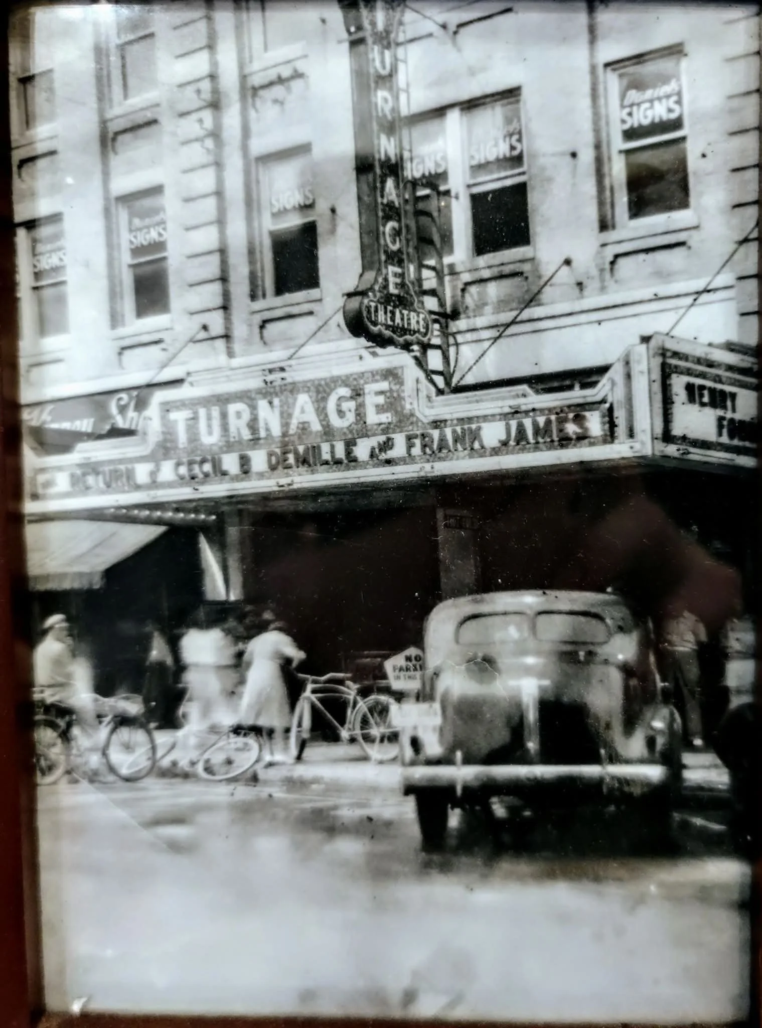 Front of Theatre with bikes & cars.jpg