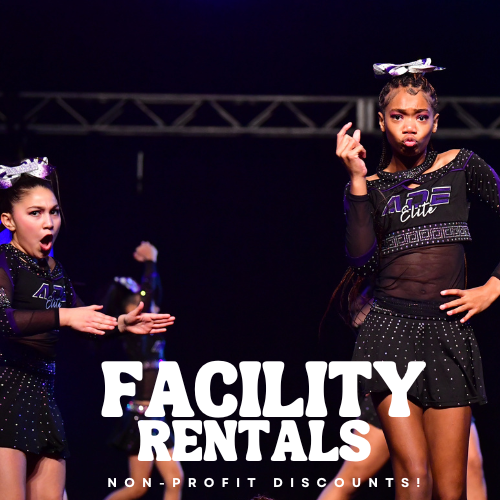 Two young female cheerleaders performing on stage, wearing black uniforms with purple accents, with a dark background. The text overlay reads 'FACILITY RENTALS, NON-PROFIT DISCOUNTS!'