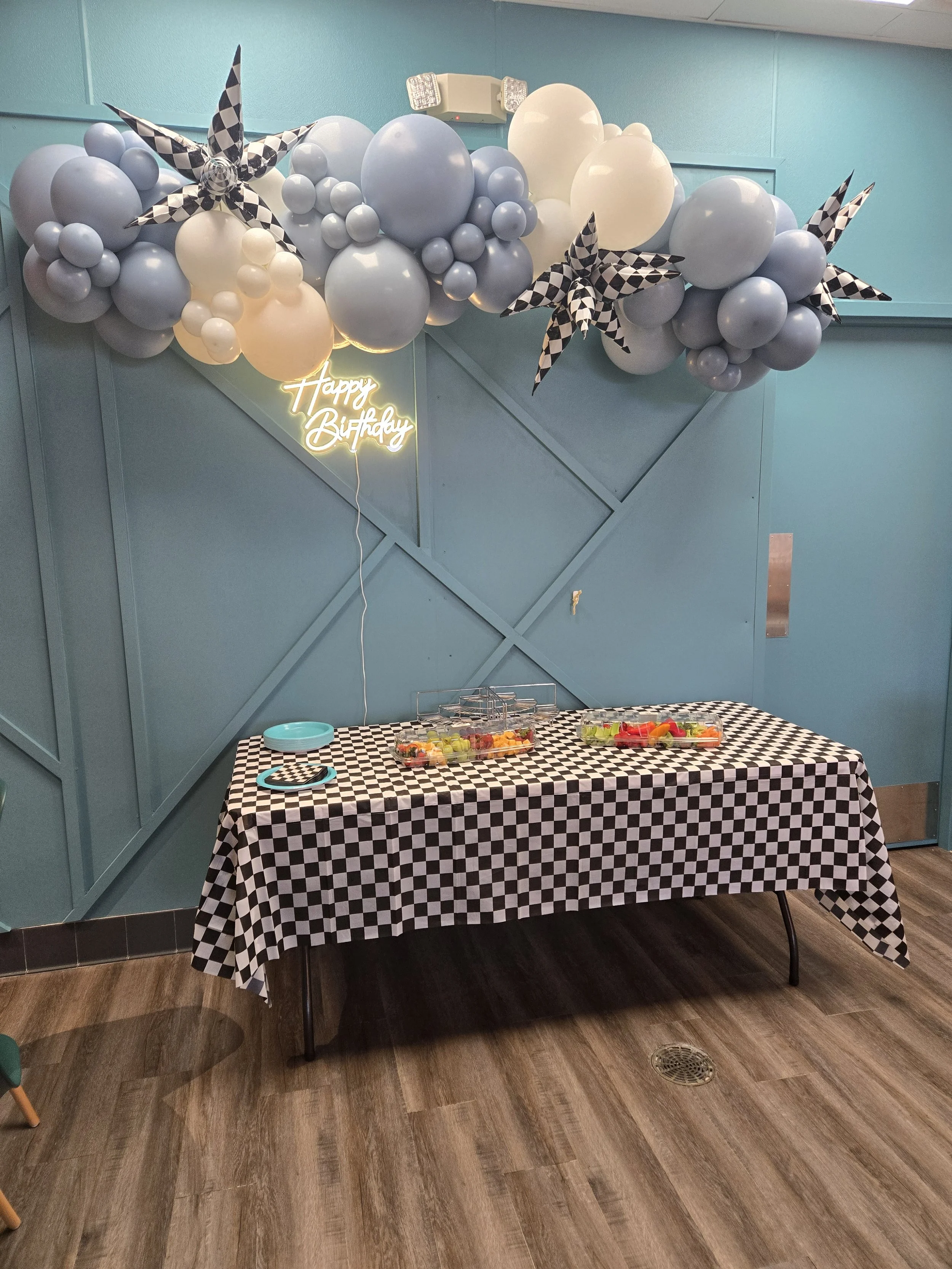 A cluster of colorful balloons floating against a dark blue sky.