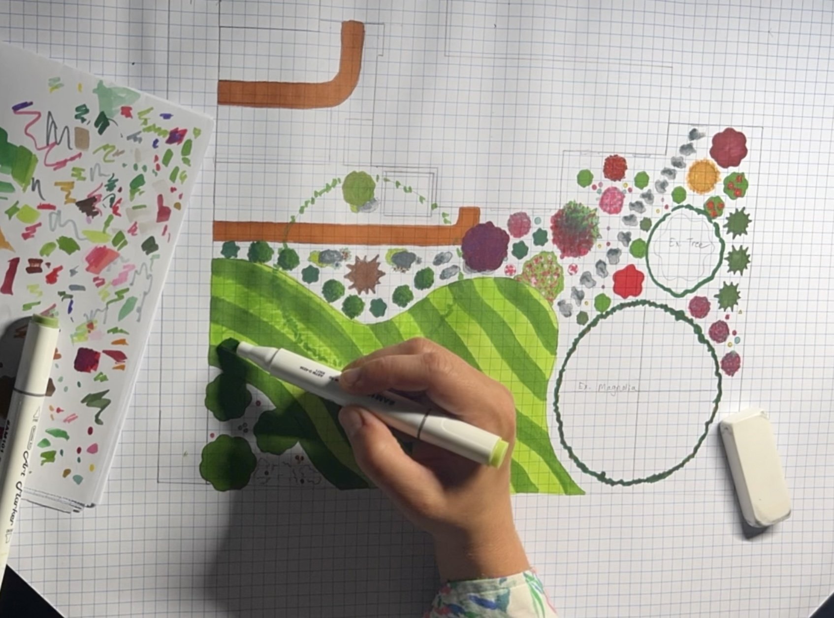 Modern house with wooden exterior, stone steps leading up to it, and mountains in the background.