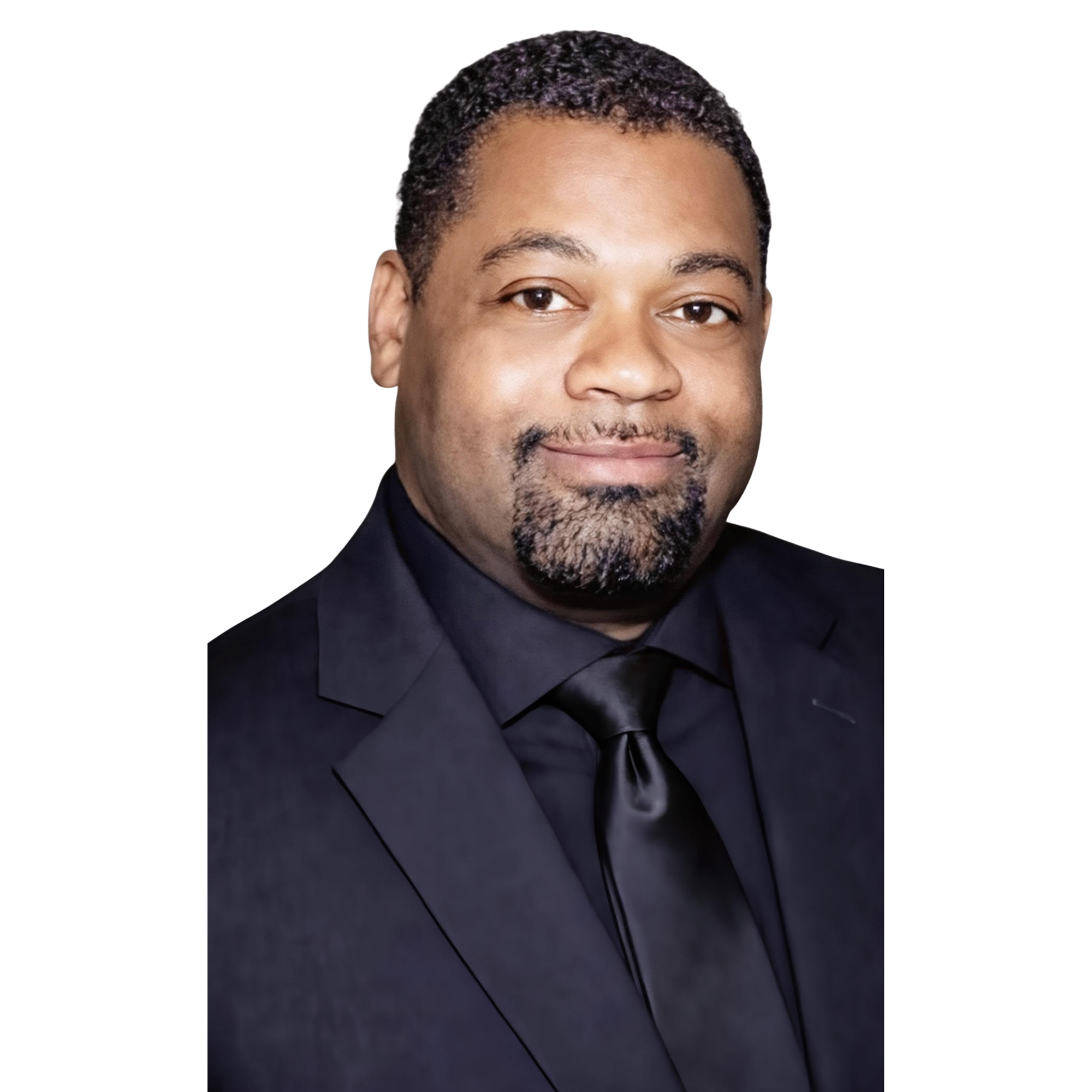 Portrait of a man in a dark suit, black shirt, and black tie, smiling slightly with short curly hair and a beard.