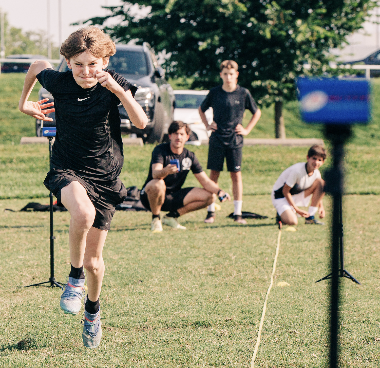 Footie Fit athletes training with timing gates on a soccer field