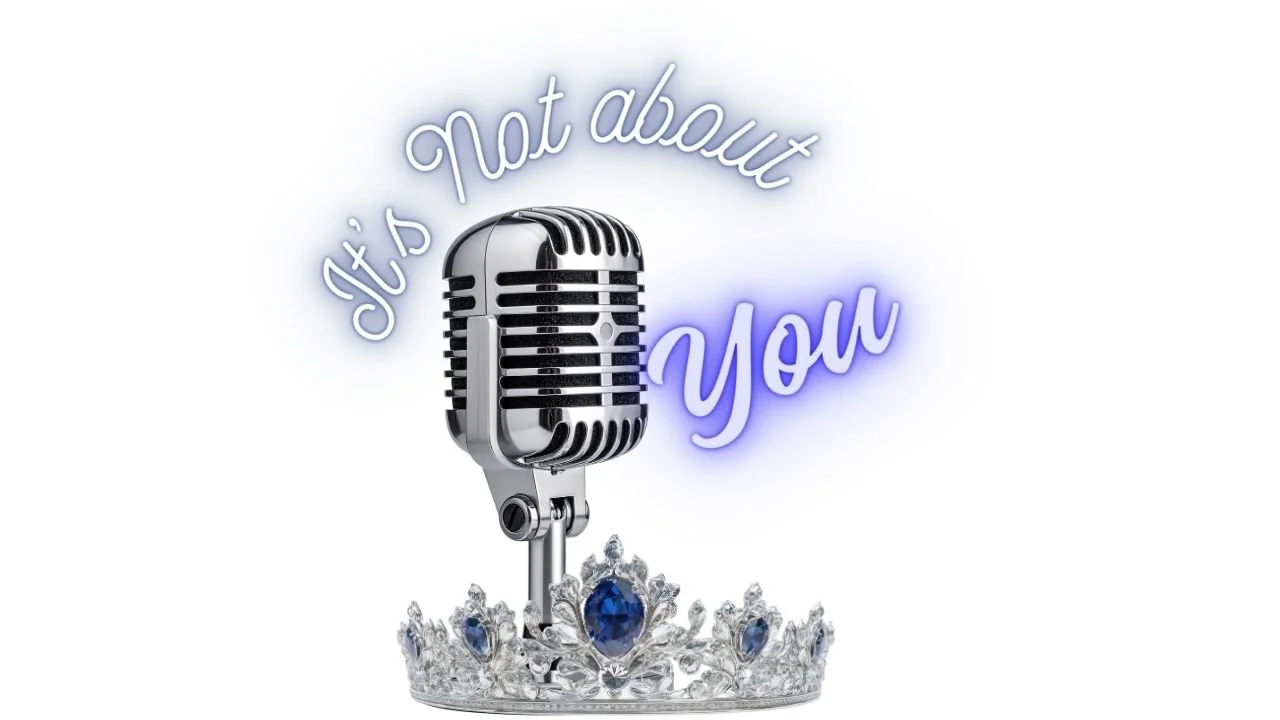 A vintage microphone on a jeweled crown with blue gemstones, with neon text saying "It's Not About You" in cursive font.