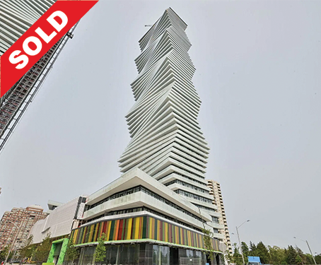 Tall modern skyscraper with a twisted, irregular design and a colorful base, with a 'SOLD' sign in the top left corner.