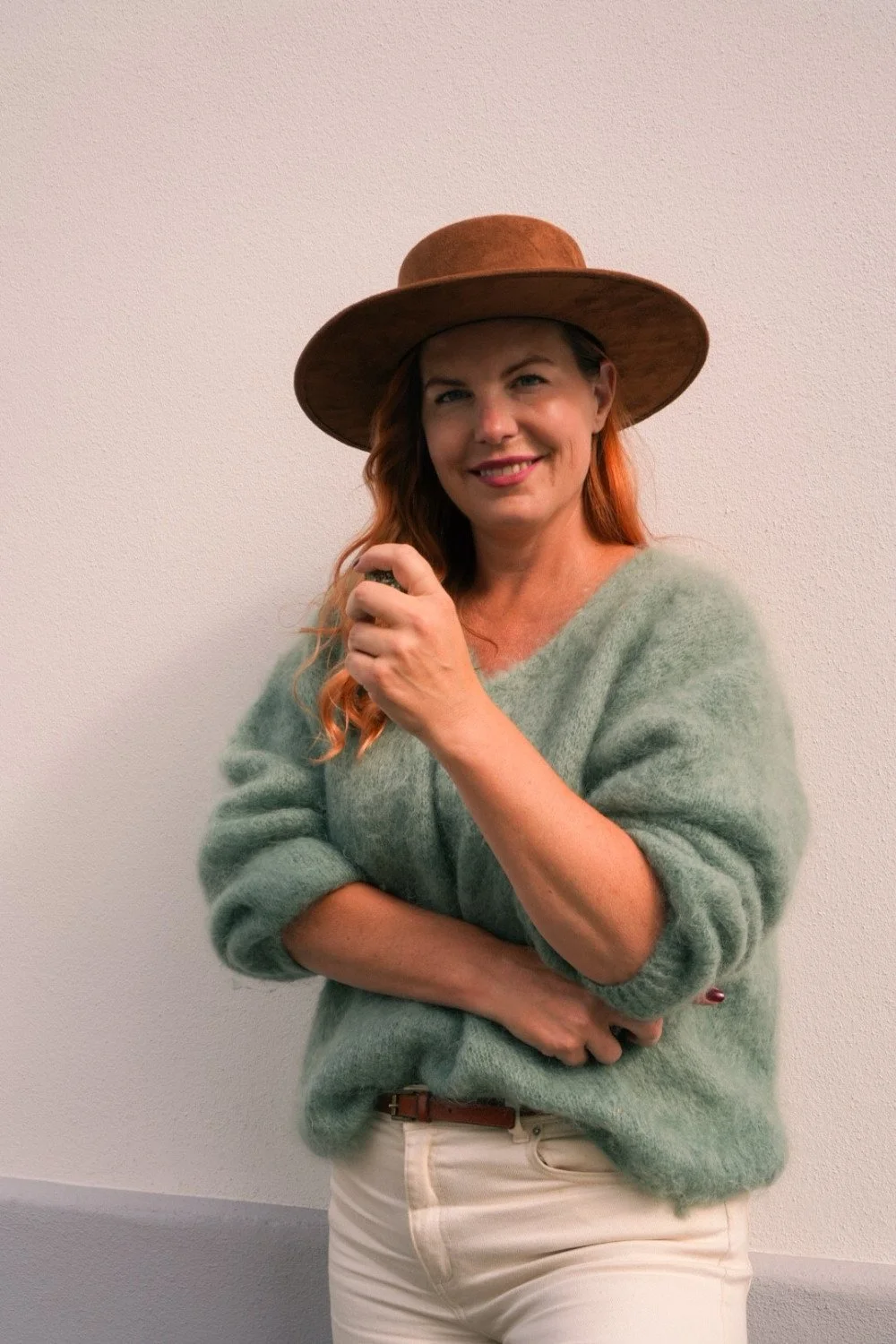 Louise wearing a wide-brimmed brown hat