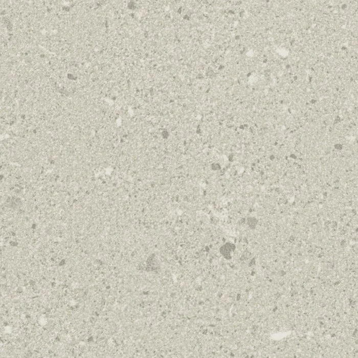 Close-up of a speckled beige or light gray textured surface, possibly a concrete or stone material.