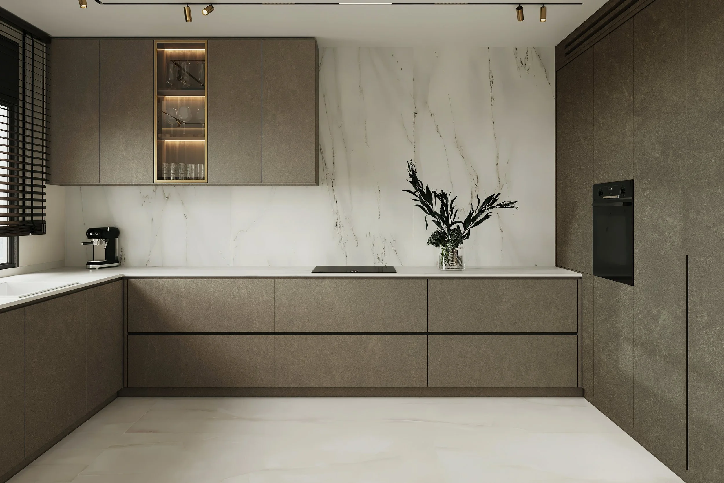 Modern kitchen with beige cabinets, white marble backsplash, black oven, black coffee maker, and glass vase with black and green foliage.